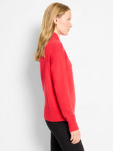 Load image into Gallery viewer, Woman wearing a red sweater and black pants against a white background.
