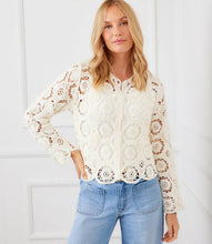 Load image into Gallery viewer, Woman wearing a cream crochet jacket and blue jeans against a white background.
