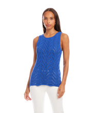 Load image into Gallery viewer, Woman wearing a blue sleeveless top  and white pants against a white background.
