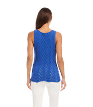 Load image into Gallery viewer, Woman wearing a blue sleeveless top  and white pants against a white background.
