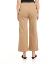 Load image into Gallery viewer, Close-up of model wearing beige cropped pants and black flats against a white background.

