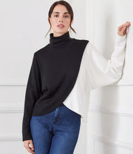 Load image into Gallery viewer, Prepare to embrace stylish comfort with our Crossover Colorblock Top. Crafted from soft sweater knit fabric, this top showcases an asymmetrical hem and dolman sleeves for a laid-back fit. It&#39;s ideal for infusing your wardrobe with character.
