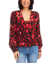 Load image into Gallery viewer, This Karen Kane top features a stylish crossover neck design and blouson sleeves. Made from high-quality fabric, it offers a relaxed fit and pullover style, perfect for both casual and formal occasions. The allover print adds a touch of elegance, making it a versatile addition to any wardrobe.
