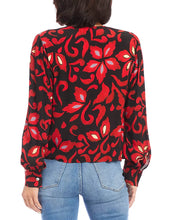 Load image into Gallery viewer, This Karen Kane top features a stylish crossover neck design and blouson sleeves. Made from high-quality fabric, it offers a relaxed fit and pullover style, perfect for both casual and formal occasions. The allover print adds a touch of elegance, making it a versatile addition to any wardrobe.
