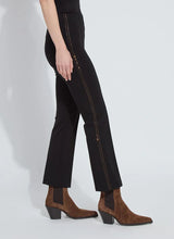 Load image into Gallery viewer, Model wearing black pants with bronze rhinestone accents and brown boots against a white background.
