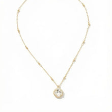 Load image into Gallery viewer, Gold necklace with a clear pendant on a white background.
