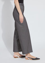 Load image into Gallery viewer, Person wearing black sheen line jean, black tee and black flats against a white background.
