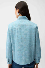 Load image into Gallery viewer, Model wearing a sequin light blue textured jacket and blue jeans against a white background.
