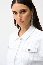 Load image into Gallery viewer, Woman wearing a white jacket with rhinestones and long silver earrings against a light background.
