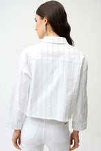 Load image into Gallery viewer, Woman wearing a white denim jacket with rhinestones and white pants on a white background.
