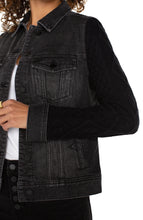 Load image into Gallery viewer, This jacket offers a contemporary twist on a classic design, blending the durable charm of denim with the snug comfort of knitwear. It boasts a button-front closure, a pointed collar, and chest pockets, all within a timeless silhouette. The contrasting knit sleeves provide a distinctive flair. Made from a soft, textured knit, the sleeves ensure both comfort and fashion, setting this jacket apart.
