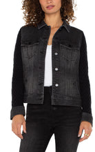 Load image into Gallery viewer, This jacket offers a contemporary twist on a classic design, blending the durable charm of denim with the snug comfort of knitwear. It boasts a button-front closure, a pointed collar, and chest pockets, all within a timeless silhouette. The contrasting knit sleeves provide a distinctive flair. Made from a soft, textured knit, the sleeves ensure both comfort and fashion, setting this jacket apart.
