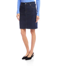 Load image into Gallery viewer, Model wearing a dark blue denim skirt, blue top and black heels against a white background.
