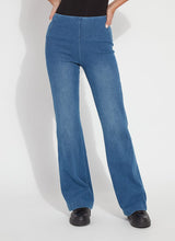 Load image into Gallery viewer, Model wearing mid wash blue denim trouser, black loafers and black top against a white background.
