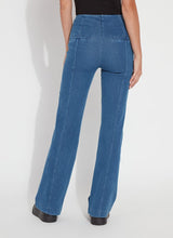 Load image into Gallery viewer, Model wearing mid wash blue denim trouser, black loafers and black top against a white background.
