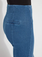 Load image into Gallery viewer, Close-up of mid wash denim blue jeans with a back welt pocket against a white background.
