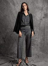 Load image into Gallery viewer, Woman wearing a dark blazer, gray shirt, plaid wide-leg pants and black sandals against a textured gray background.
