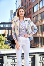 Load image into Gallery viewer, Experience the allure of a painted desert sky with this Liquid Desert Dream Metallic Faux Leather Jacket. Showcasing a striking blend of colors, this moto jacket features a sleek glossy exterior and faux zipper accents that add an edgy touch. Versatile enough for any occasion, from formal to relaxed. Color- Light purples, pink, mint. Metallic printed vegan pleather. Hook &amp; eye closure. Gold zipper trim.
