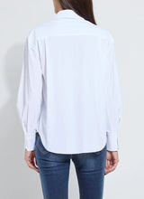 Load image into Gallery viewer, Model wearing a white long sleeve shirt and blue jeans against a plain background.
