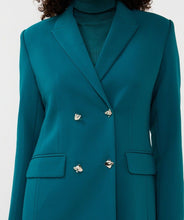 Load image into Gallery viewer, Close-up of front of teal blazer dress and gold buttons worn by model against a white background.

