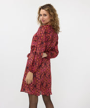 Load image into Gallery viewer, If you&#39;re in search of a dress with a distinctive, colorful print, our Sensation print dress is the perfect choice! It features a bow belt and buttons up to the waist. Crafted with an exterior of 100% polyester and a lining of 100% viscose, it not only maintains its beauty over time but also offers comfort.
