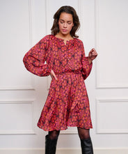 Load image into Gallery viewer, If you&#39;re in search of a dress with a distinctive, colorful print, our Sensation print dress is the perfect choice! It features a bow belt and buttons up to the waist. Crafted with an exterior of 100% polyester and a lining of 100% viscose, it not only maintains its beauty over time but also offers comfort.
