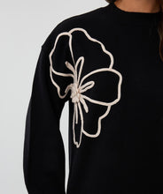 Load image into Gallery viewer, Black sweater dress with a cream floral design against a white background.
