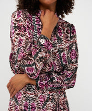 Load image into Gallery viewer, Woman wearing a zebra patterned dress with long sleeves against a white background.
