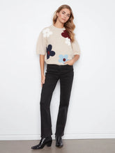 Load image into Gallery viewer, Woman wearing an elbow sleeve sweater with multicolor flowers, black pants and black boots against a white background.
