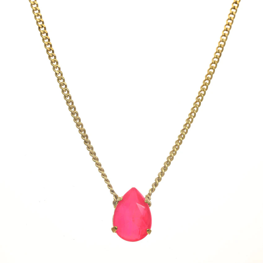 Introducing the Lumi necklace, a dazzling and versatile piece adorned with a high-quality pear-shaped stone in the middle. This antique gold-plated necklace features a 14” length with a 3” extension. Handcrafted in Canada.    Color- Gold and electric pink. Premium crystals. Tear drop in electric pink. Gold chain. Length- 14 inches with 3-inch extension. 