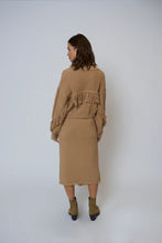 Load image into Gallery viewer, Woman wearing a tan sweater, tan long skirt and tan boots against a white background.
