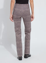 Load image into Gallery viewer, Model wearing patterned pants, black top and black shoes against a white background.
