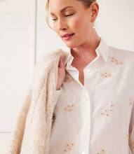 Load image into Gallery viewer, Enhance your closet with our expertly hand-embroidered embellished button up shirt. Delicately hand stitched flowers in a soft almond hue decorate this classic off white garment, adding a refined and sophisticated touch.
