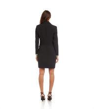 Load image into Gallery viewer, Woman wearing a black coat dress and black strappy heels against a white background.
