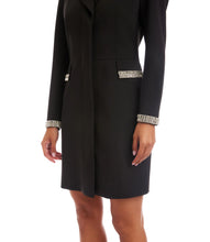 Load image into Gallery viewer, Close-up of model wearing black coat dress with rhinestone decorative trim on cuffs and pockets against a white background.
