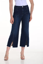 Load image into Gallery viewer, Person wearing dark blue wide-leg jeans with sparkle and nude heels on a white background.

