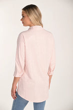 Load image into Gallery viewer, Woman wearing a light pink sequined shirt and blue jeans on a white background.
