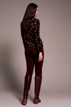 Load image into Gallery viewer, Woman wearing a black velvet with tonal flowers top, brown pants with burgundy boots against a plain background.
