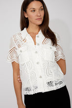 Load image into Gallery viewer, Woman wearing an off-white blouse with heart embroidery and rhinestone heart buttons and black pants against a white background.

