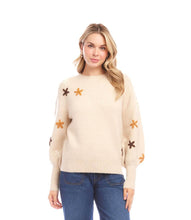 Load image into Gallery viewer, Woman wearing a cream sweater with embroidered flowers against a white background.
