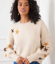 Load image into Gallery viewer, Woman wearing a cream floral embroidered sweater and jeans against a white background.
