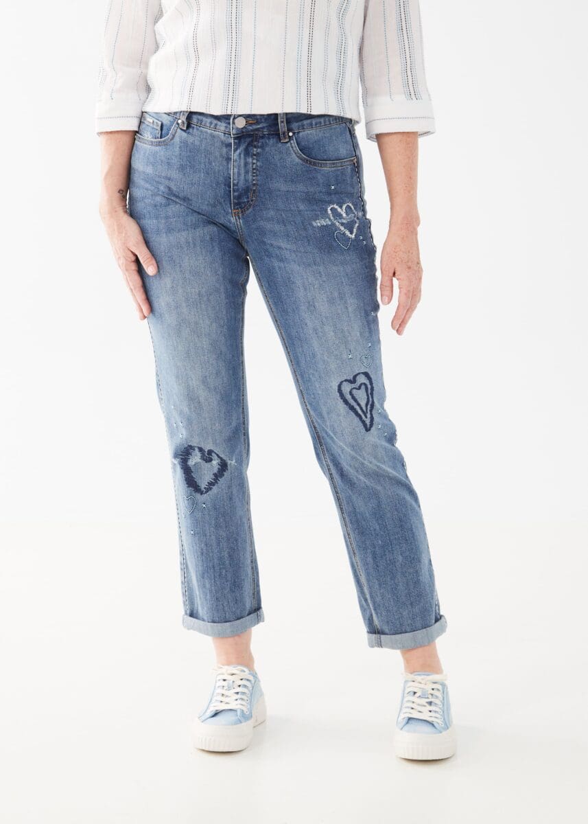 This jean is a must-have addition to any denim collection, with its charming embroidered hearts and eye-catching embellishments. In addition, slight distressing gives this jean extra edge!  Color- Light blue. Embellishments. Slight distressing. Mid-rise. Button and zip fly. Low stretch.