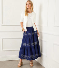 Load image into Gallery viewer, Flowing and feminine, the Karen Kane Embroidered Tiered Midi Skirt is a must-have for effortless style. Designed with three cascading tiers, each adorned with intricate white embroidery, this skirt adds a touch of texture and contrast to your look.
