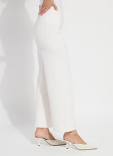 Load image into Gallery viewer, Model wearing chalk white wide-leg pants and white heels against a light gray background.
