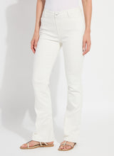 Load image into Gallery viewer, Model wearing white denim and beige sandals against a plain background.
