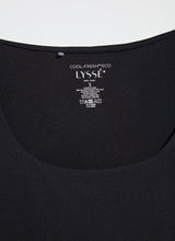 Load image into Gallery viewer, Constructed from COOL-FRESH™ ECO Jersey, the Evie Scoop Neck Tank features a wide, modern strap and a U-shape neckline, providing full coverage while keeping you cool and dry. Its double-self front and single layer back ensure opacity, and its sustainable design using recycled plastic bottle fibers makes it a conscious choice. Wear this versatile piece with jeans, shorts, or skirts for a stylish everyday look.
