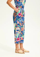Load image into Gallery viewer, Step into comfort and flair with these contrasting floral pull-on pants. Designed for effortless style, these wide-leg cropped pants feature eyelet detailing and a vivid camo floral print, making them a standout piece in any wardrobe.
