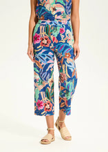 Load image into Gallery viewer, Step into comfort and flair with these contrasting floral pull-on pants. Designed for effortless style, these wide-leg cropped pants feature eyelet detailing and a vivid camo floral print, making them a standout piece in any wardrobe.

