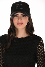 Load image into Gallery viewer, A woman wearing a black baseball cap with 'FL' embellished with silver embellishments on the front, paired with a black lace top, against a plain white background.
