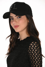 Load image into Gallery viewer, A woman wearing a black baseball cap with 'FL' embellished with silver embellishments on the front, paired with a black lace top, against a plain white background.
